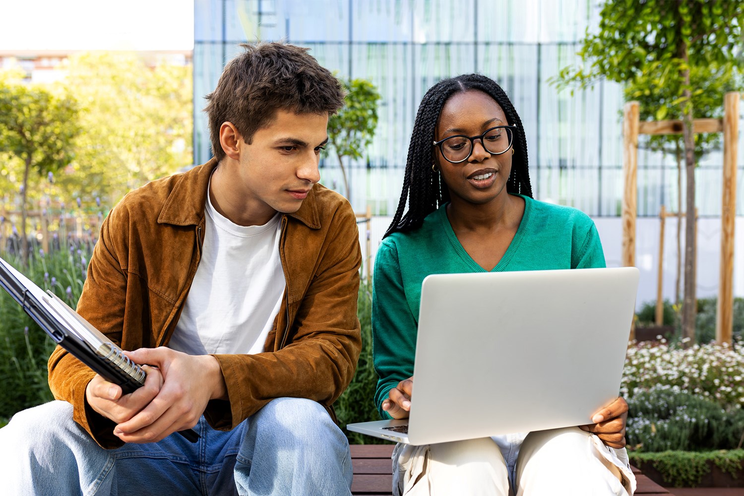 Two students using a laptop